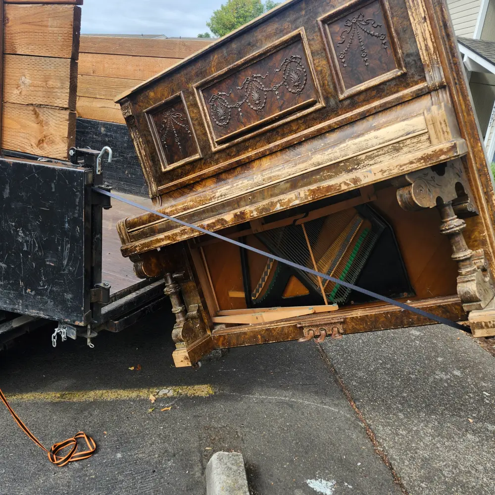 Antique upright piano loaded onto a trailer during a Salem, OR piano removal
